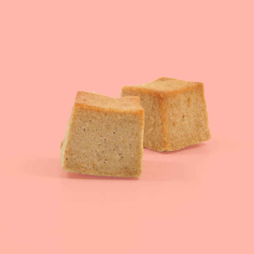Two Salmon Supreme Skipper's Dog Treat on a Pink Background